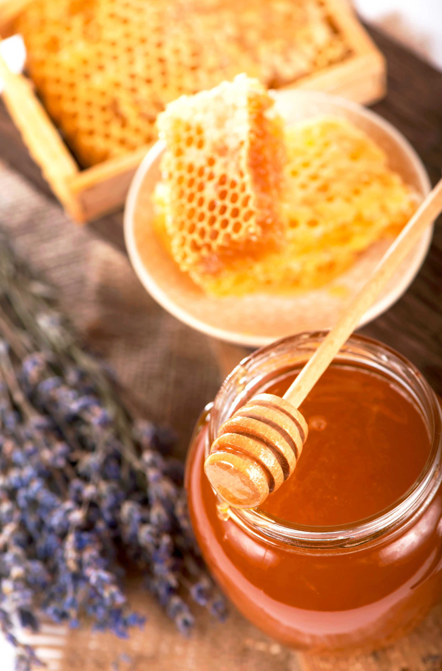 glass pot with floral honey isolated on white background.